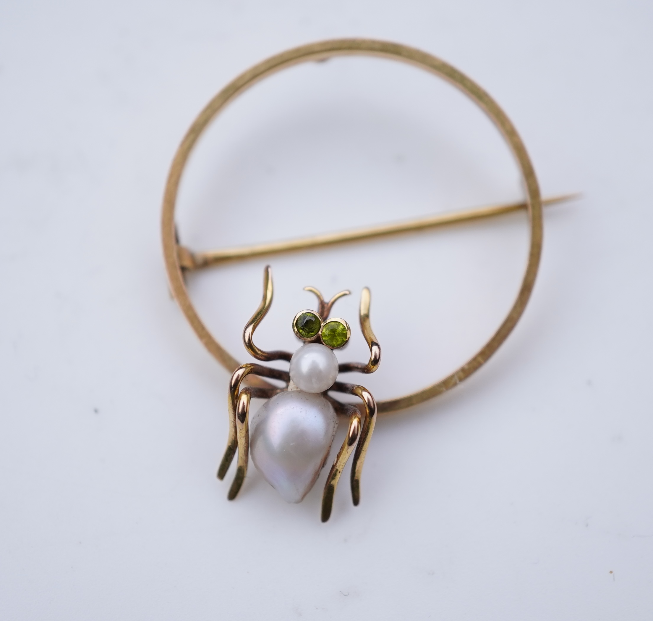 A n Edwardian gold pearl and peridot novelty brooch, early 20th century